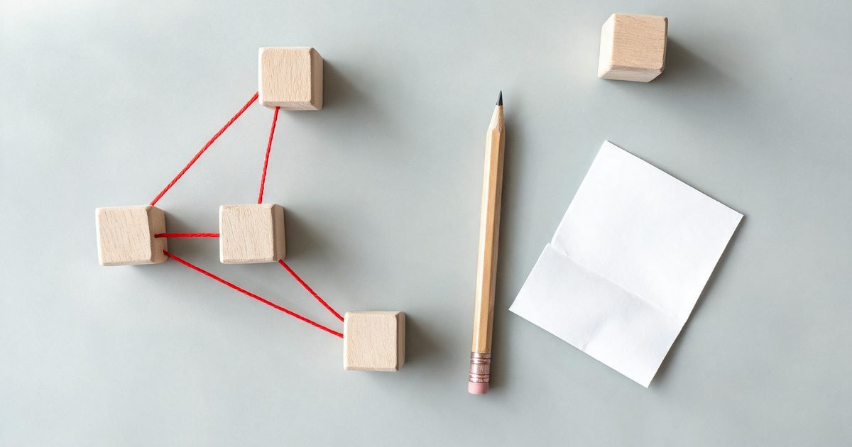 A flat lay photograph of wooden cubes in a branching pattern connected by red thread, showing the artifact graph that agentic meta-reasoning builds as a run progresses