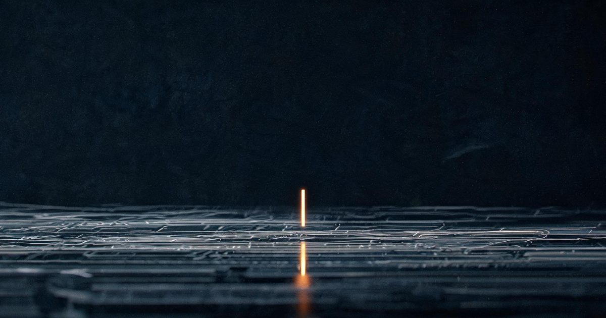 A dark editorial illustration of a wide horizontal stream of code lines flowing continuously past a single bright vertical marker, representing continuous monitoring in Claude Security
